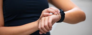woman using smartwatch on wrist